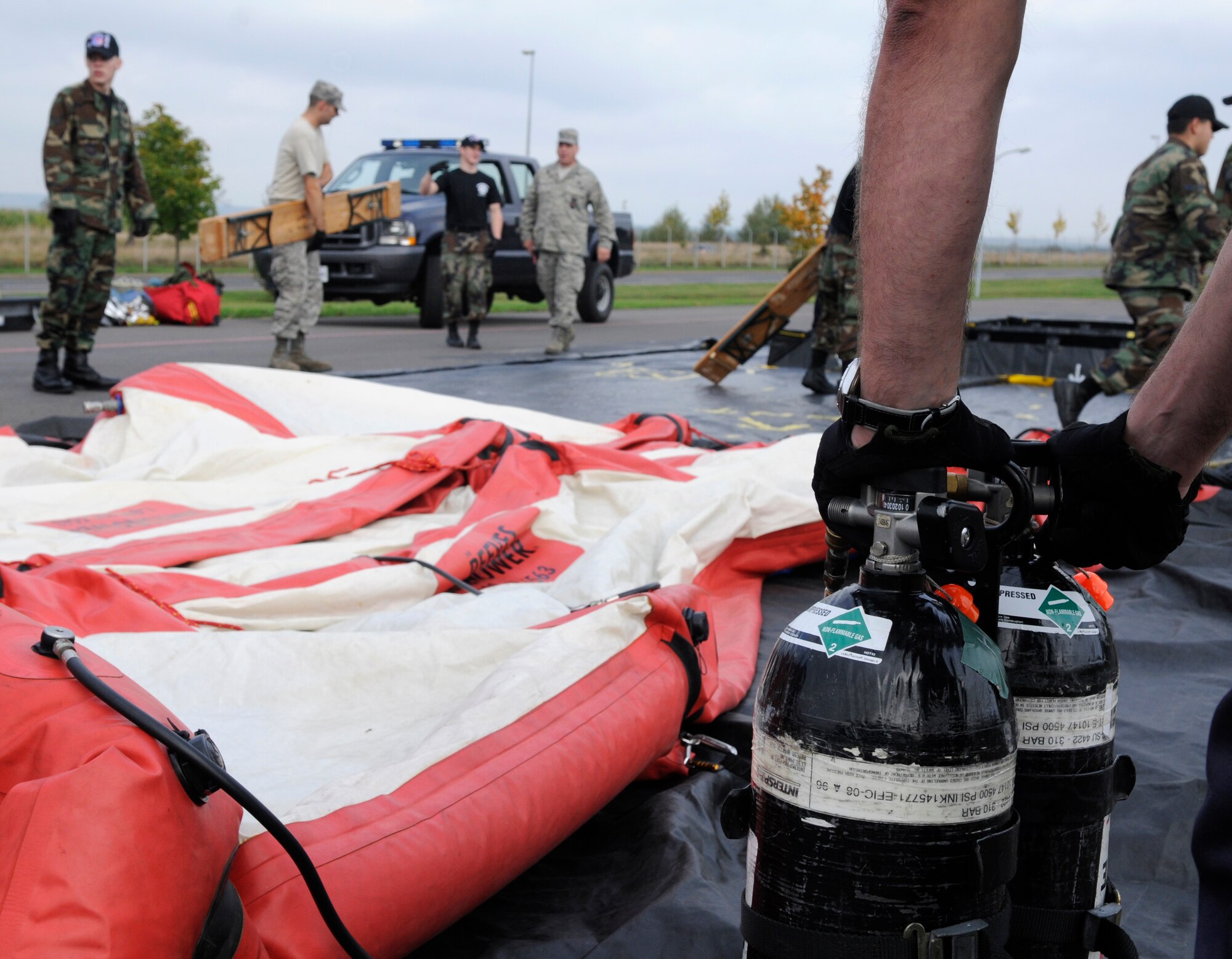 SPANGDAHLEM AIR BASE, Germany – Robert Widowsky, 52nd Civil Engineer Squadron, inflates a decontamination shower to use during an all hazards response training emergency management and mass casualty exercise Oct. 7. (U.S. Air Force photo/Airman 1st Class Staci Miller)