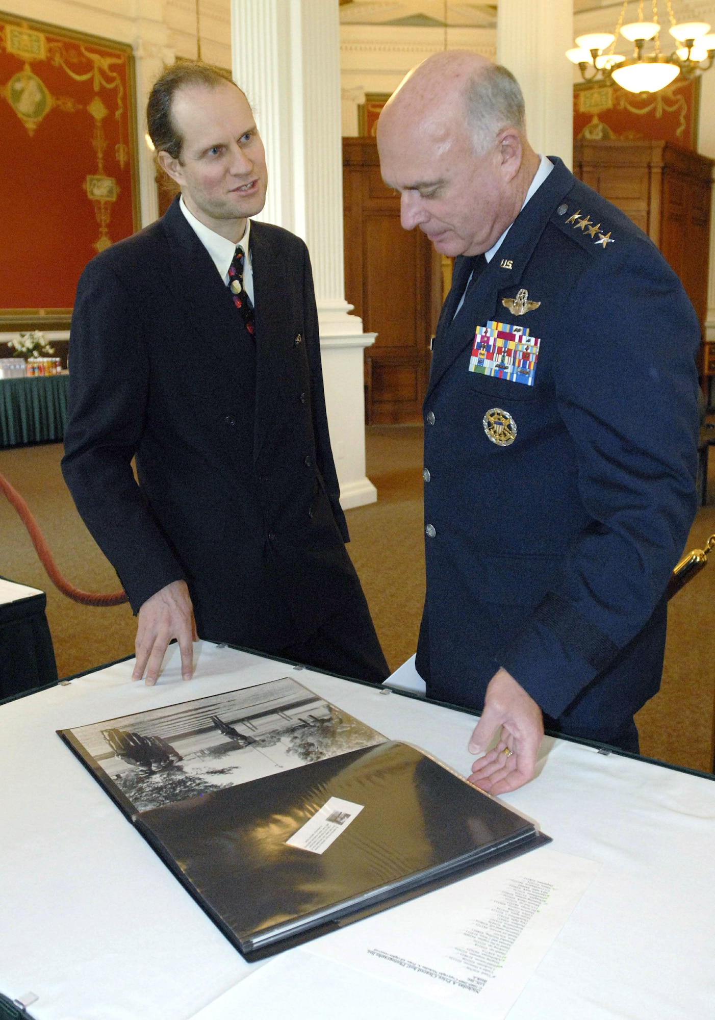 Gen. Carrol H. "Howie" Chandler discusses Air Force imagery with photographer Nicholas Price at the Library of Congress Oct. 6, 2009, in Washington, D.C. The event was the official ceremony welcoming the acquisition of 60 images from the 'Cleared Hot!' Fine Art Photography Collection of the Air Force by Nicholas Price to the library. General Chandler is the Air Force vice chief of staff. (U.S. Air Force photo/Master Sgt. Stan Parker)