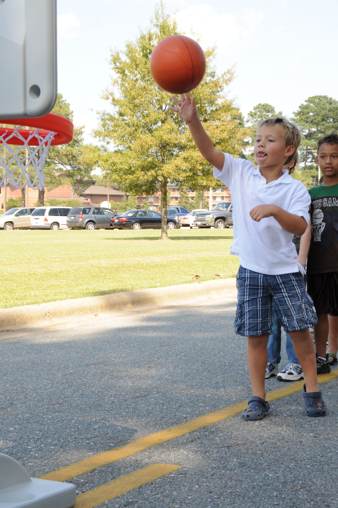 A family member plays a game of basketball during the 916th Air Refueling Wing Family Day on Oct. 3, 2009. U.S. Air Force photo by TSgt. Gillian Albro, 916ARW/PA.