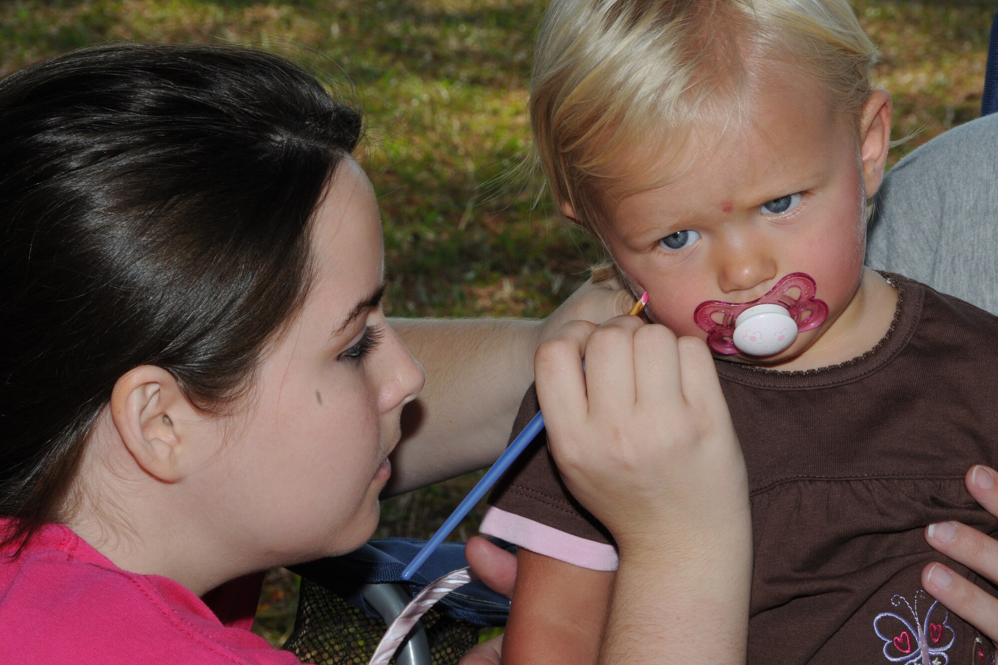A family member gets her face painted during the Family Day Picnic Oct. 3.  (U.S. Air Force photo by Gillian M. Albro, 916th ARW/PA)