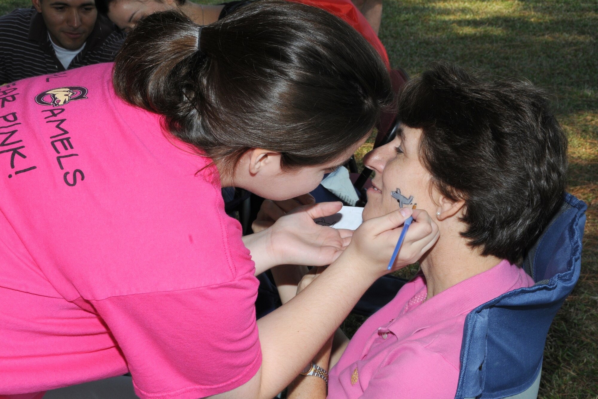 Col. Caroline Evernham, 916th Operations Group commander, has an airplane painted on her cheek during the Family Day Picnic Oct. 3.  (U.S. Air Force photo by Gillian M. Albro, 916th ARW/PA)