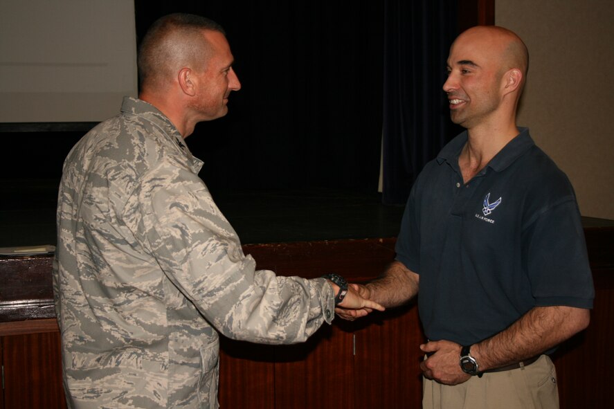 RAF CROUGHTON, United Kingdom - Staff. Sgt. Ray Hyczko is recognized by Col. Timothy Cashdollar, 501st Combat Support Wing commander, for being S.H.A.R.P.!