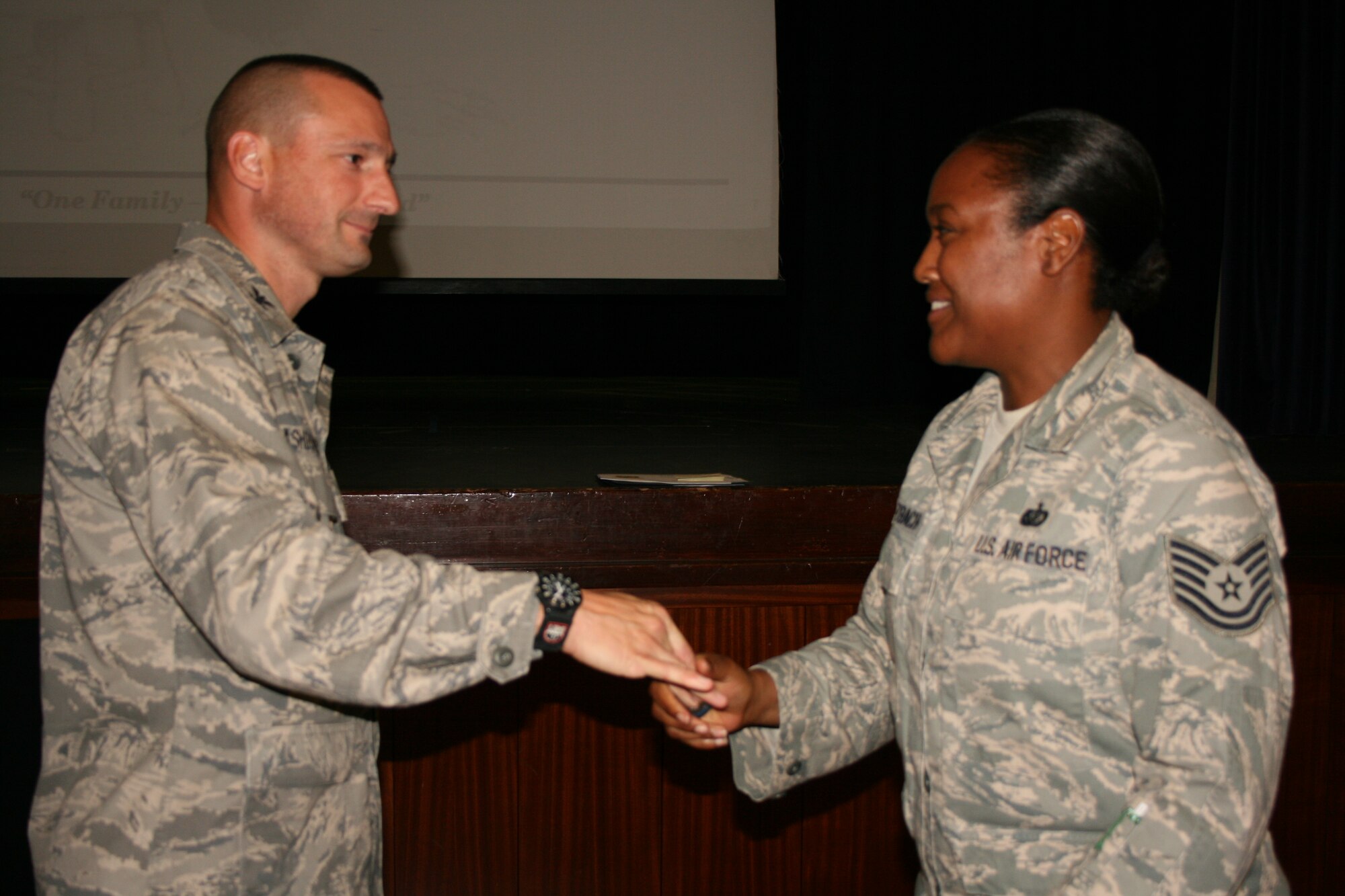 RAF CROUGHTON, United Kingdom - Tech. Sgt. Tunisia Sulzbach is recognized by Col. Timothy Cashdollar, 501st Combat Support Wing commander, for being S.H.A.R.P.!
