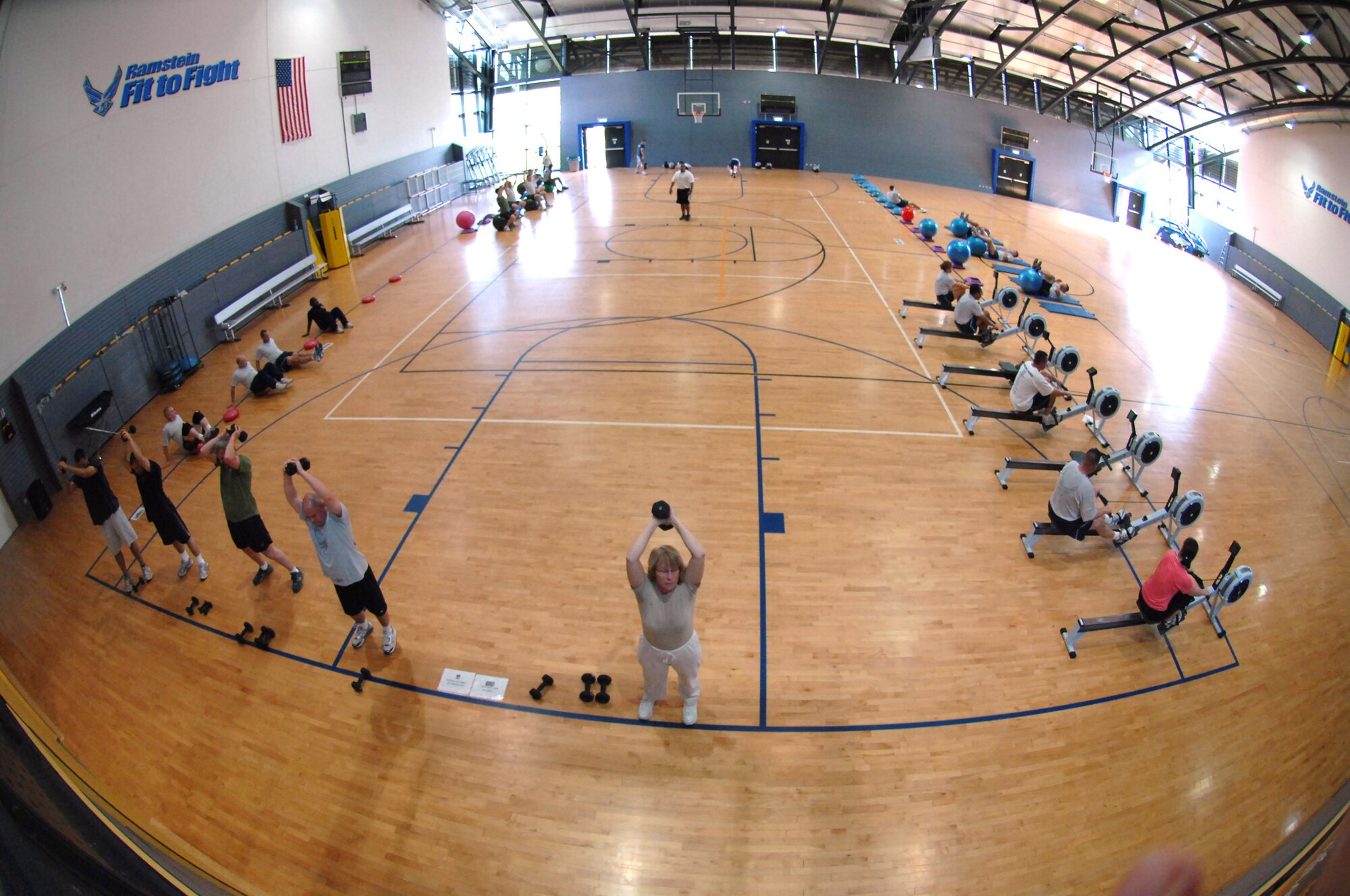 Members participate in a hardcore class workout, exercising at various stations set up in the Southside Fitness Center, Ramstein Air Base, Germany, Oct. 7, 2009. The Southside and Northside Fitness Centers here offer hardcore classes Mondays through Fridays at noon and give members a thorough core muscle workout while preparing them for the physical training test. (U.S. Air Force photo by Tech. Sgt. Michael Voss)