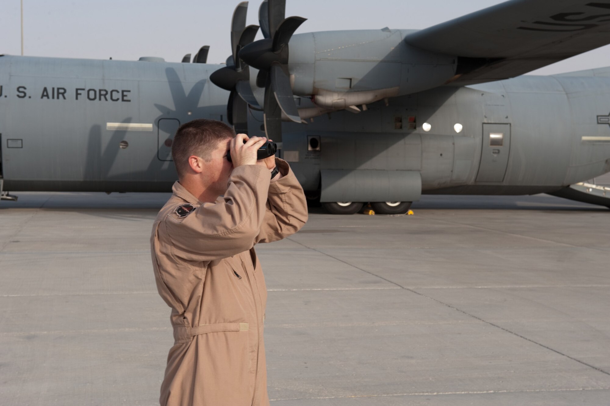 Airman 1st Class Dustin Wiley, 379th Expeditionary Security Forces Squadron Fly Away Security Team member, scans the area around a C-130 for possible security concerns, Oct. 6, in Southwest Asia. Airman Wiley, along with fellow FAST members, ensures U.S. Air Force aircraft are secure when they travel to areas with less established security. Airman Wiley is deployed from RAF Mildenhall, England, in support of Operations Iraqi and Enduring Freedom. (U.S. Air Force photo/Staff Sgt. Robert Barney)
