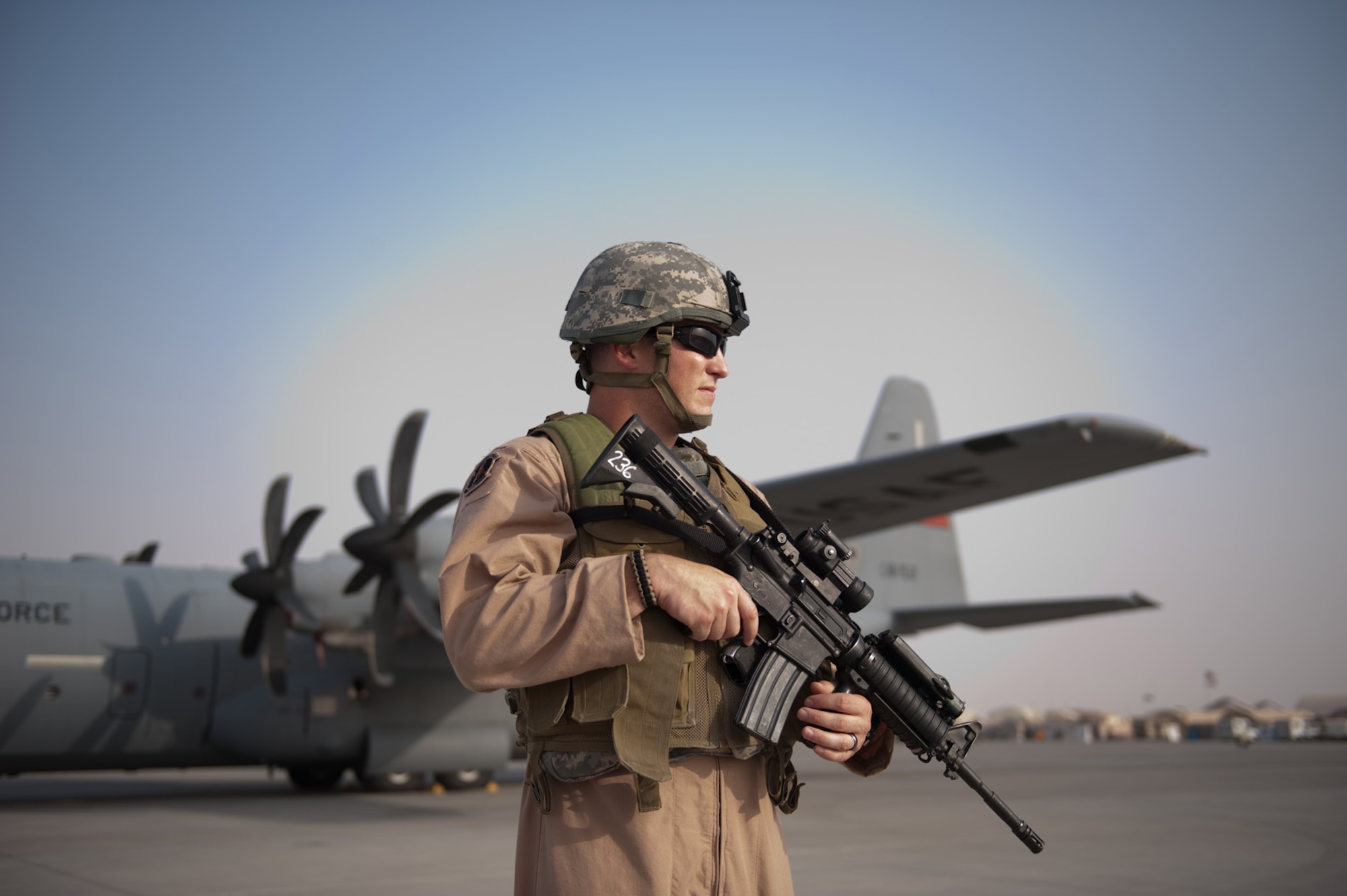 Airman 1st Class Dustin Wiley, 379th Expeditionary Security Forces Squadron Fly Away Security Team member, secures the area around a C-130, Oct. 6, in Southwest Asia. Airman Wiley, along with fellow FAST members, ensures U.S. Air Force aircraft are secure when they travel to areas with less established security. Airman Wiley is deployed from RAF Mildenhall, England, in support of Operations Iraqi and Enduring Freedom. (U.S. Air Force photo/Staff Sgt. Robert Barney) 
