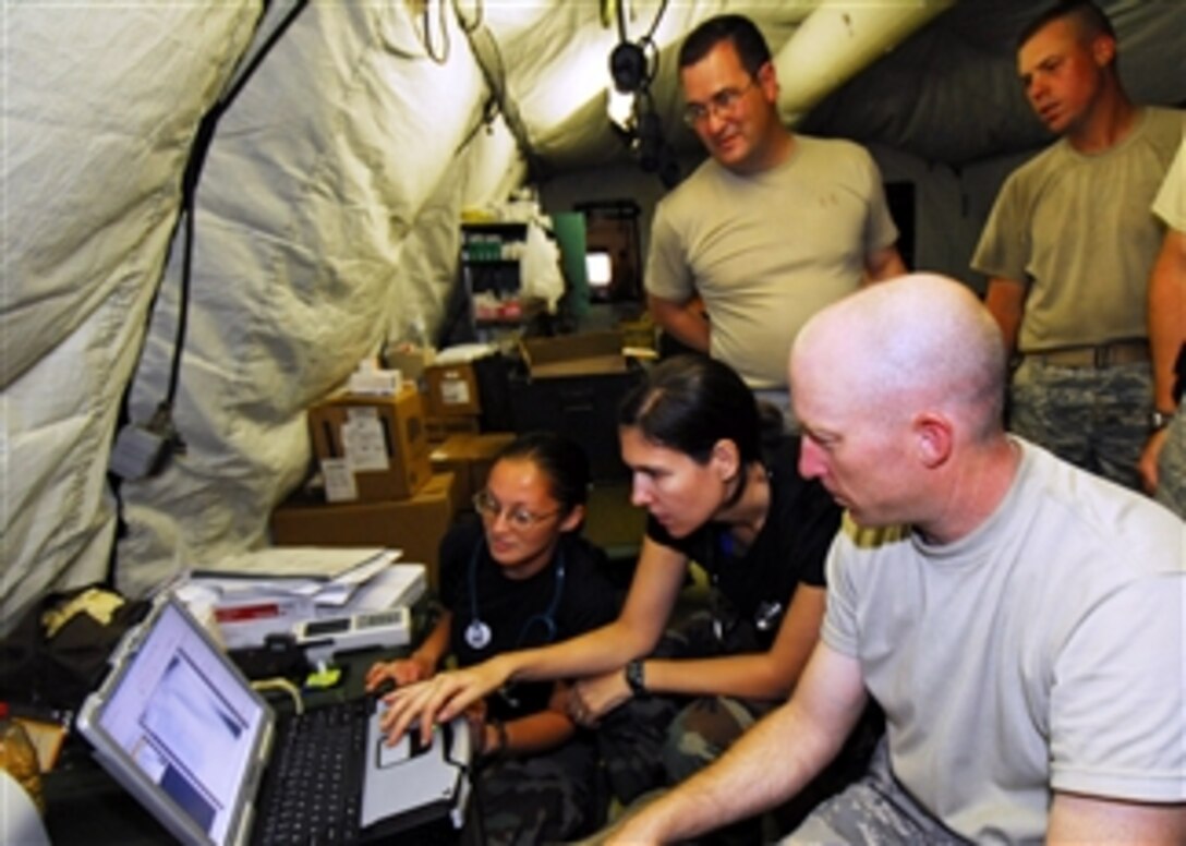 Members of the U.S. Air Force humanitarian assistance rapid response team examine an X-ray of a patient's lung in the team's mobile field hospital in Padang, Indonesia, on Oct. 7, 2009.  The team set up the hospital to provide medical care to those injured by the recent earthquake in Padang.  