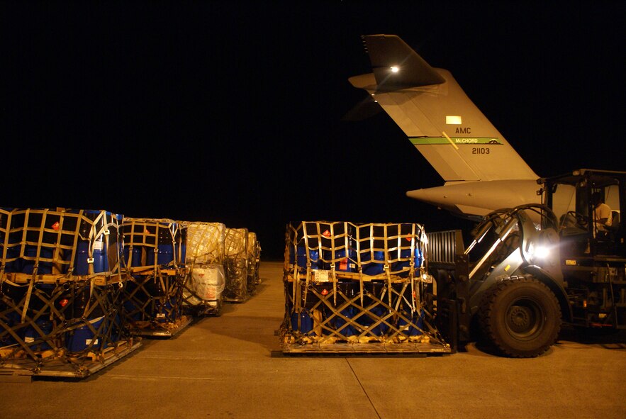 Airmen of the 36th Mobility Response Squadron, Andersen Air Force Base, Guam, utilize a forklift to off-load cargo from a C-17 Globemaster III on a humanitarian mission Oct. 9 at Minangkabau International Airport in Padang, Indonesia. (U.S. Air Force photo/Staff Sgt. Eric Burks)