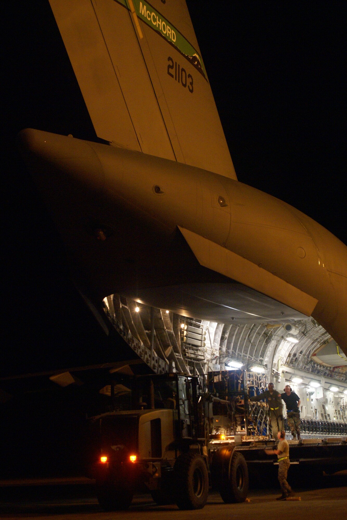 7th Airlift Squadron Airmen and members of the 36th Mobility Response Squadron, Andersen Air Force Base, Guam, off-load cargo from a McChord C-17 Globemaster III on a humanitarian mission Oct. 9 at Minangkabau International Airport in Padang, Indonesia. (U.S. Air Force photo/Staff Sgt. Eric Burks)