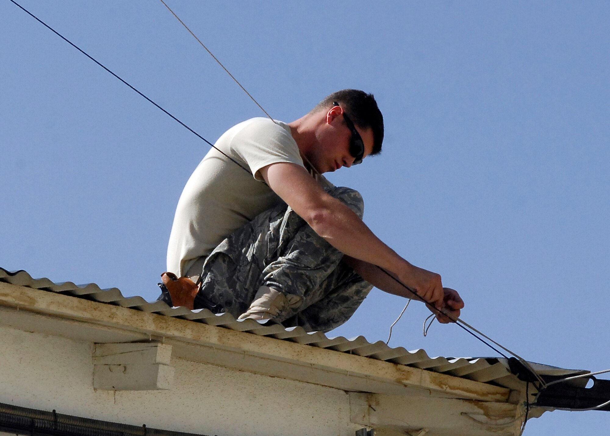 BAGRAM AIRFIELD, Afghanistan -- Airman First Class Kurtis Walter, a member of the 455th Expeditionary Security Forces Squadron, secures an antenna here, Oct. 10, 2009.  Airman Walter is deployed from MacDill Air Force Base, Fla., and hails from Holland, Mich.  (U.S. Air Force photo/Senior Airman Felicia Juenke)
