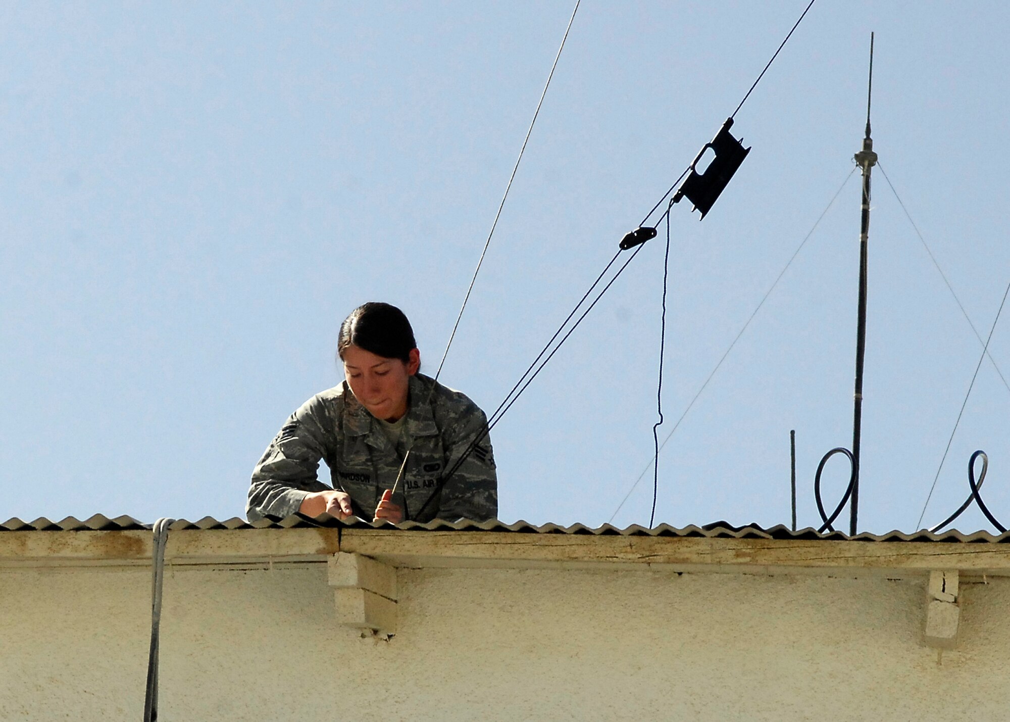 BAGRAM AIRFIELD, Afghanistan -- Senior Airman Natalie Richardson, a member of the 455th Expeditionary Security Forces Squadron, secures an antenna here, Oct. 10, 2009.  Airman Richardson, an Allentown, Pa. native, is deployed from RAF Mildenhall, UK.  (U.S. Air Force photo/Senior Airman Felicia Juenke)