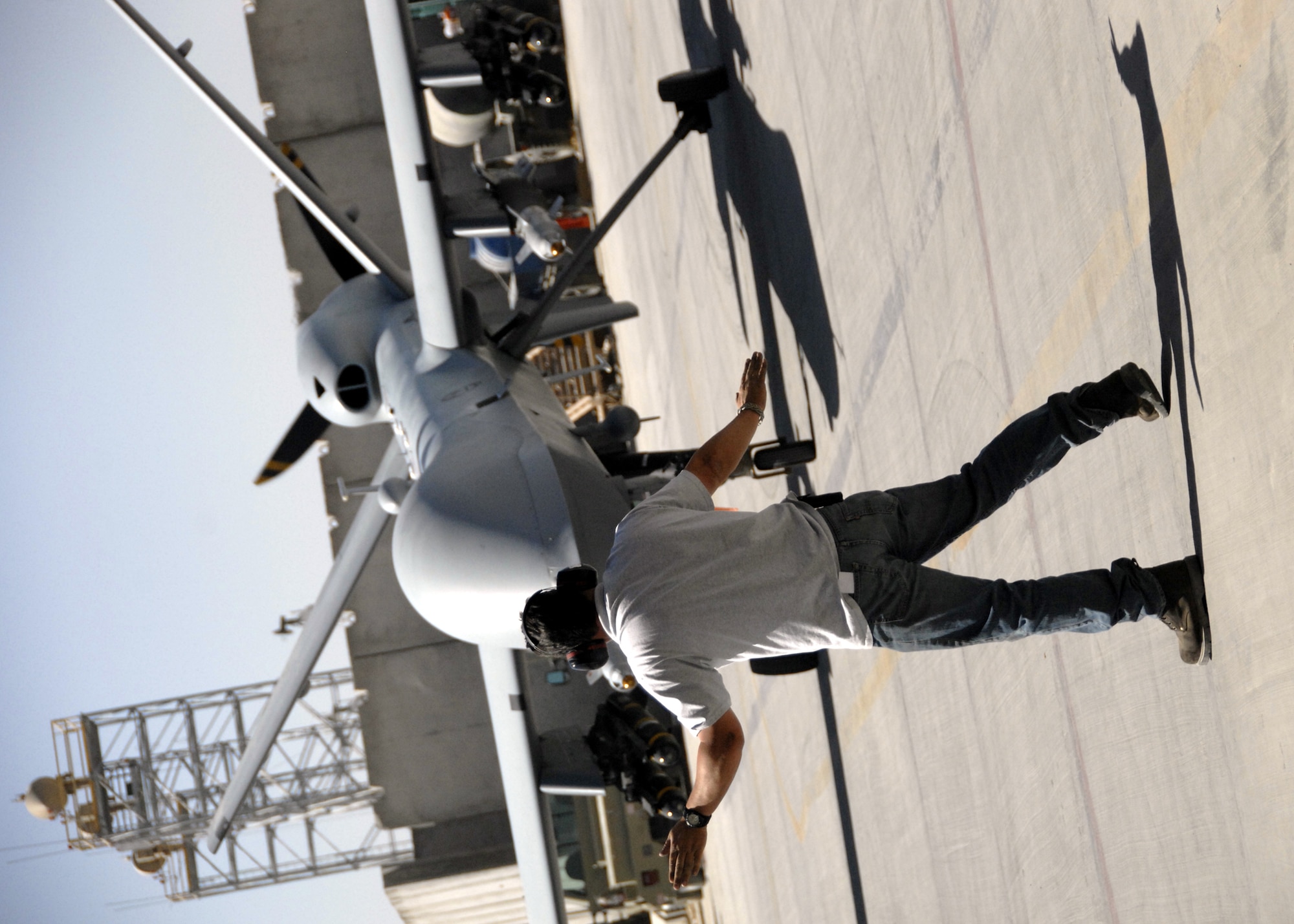 Jeff Markie taxis an MQ-9 Reaper into a hangar after recovering it from a mission here, Oct. 8, 2009. The MQ-9's primary mission is as a persistent hunter-killer against emerging targets to achieve joint force commander objectives. Mr. Markie is an Air Force contracted aircraft mechanic employed by General Atomic Aeronautical Systems from Creech Air Force Base, Nev., and hails from East Millinocket, Maine. (U.S. Air Force photo/Senior Airman Timothy Taylor)
