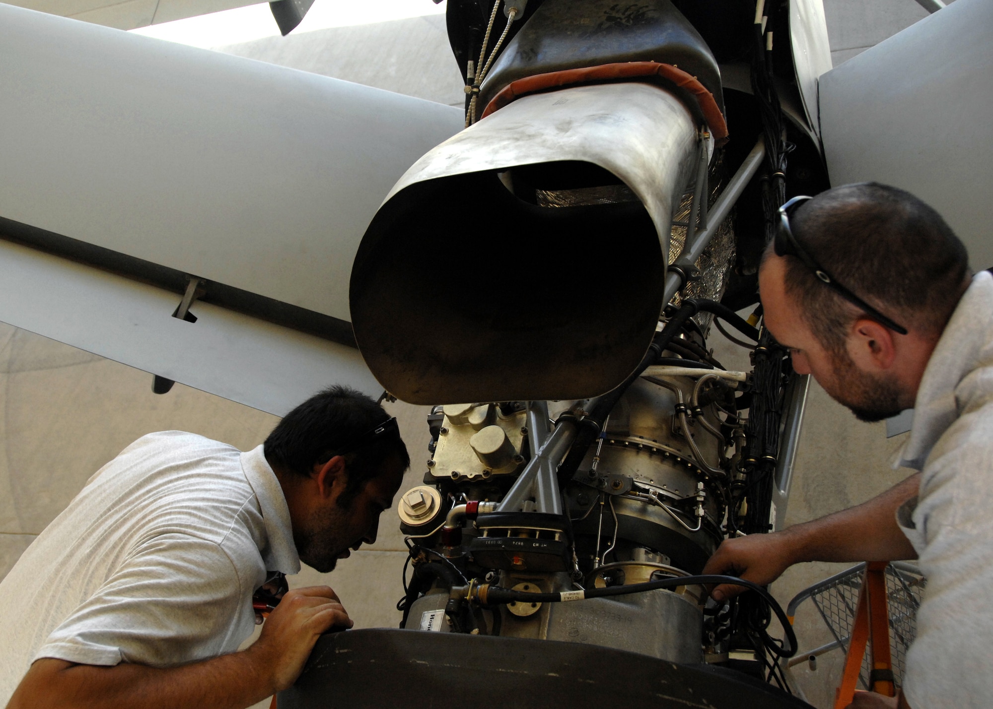 Guy Kemp and Geoge Phillips replace a prop pitch controller during engine maintenance on an MQ-9 Reaper here, Oct. 8, 2009. The MQ-9 Reaper has a 900 shaft horse power engine and is capable of travel up to speeds in excess of 230 miles per hour. Mr. Kemp and Phillips are aircraft mechanics from Creech Air Force Base, Nev., and hail from Las Vegas, Nev., and Bethel, Ohio. (U.S. Air Force photo/Senior Airman Timothy Taylor)