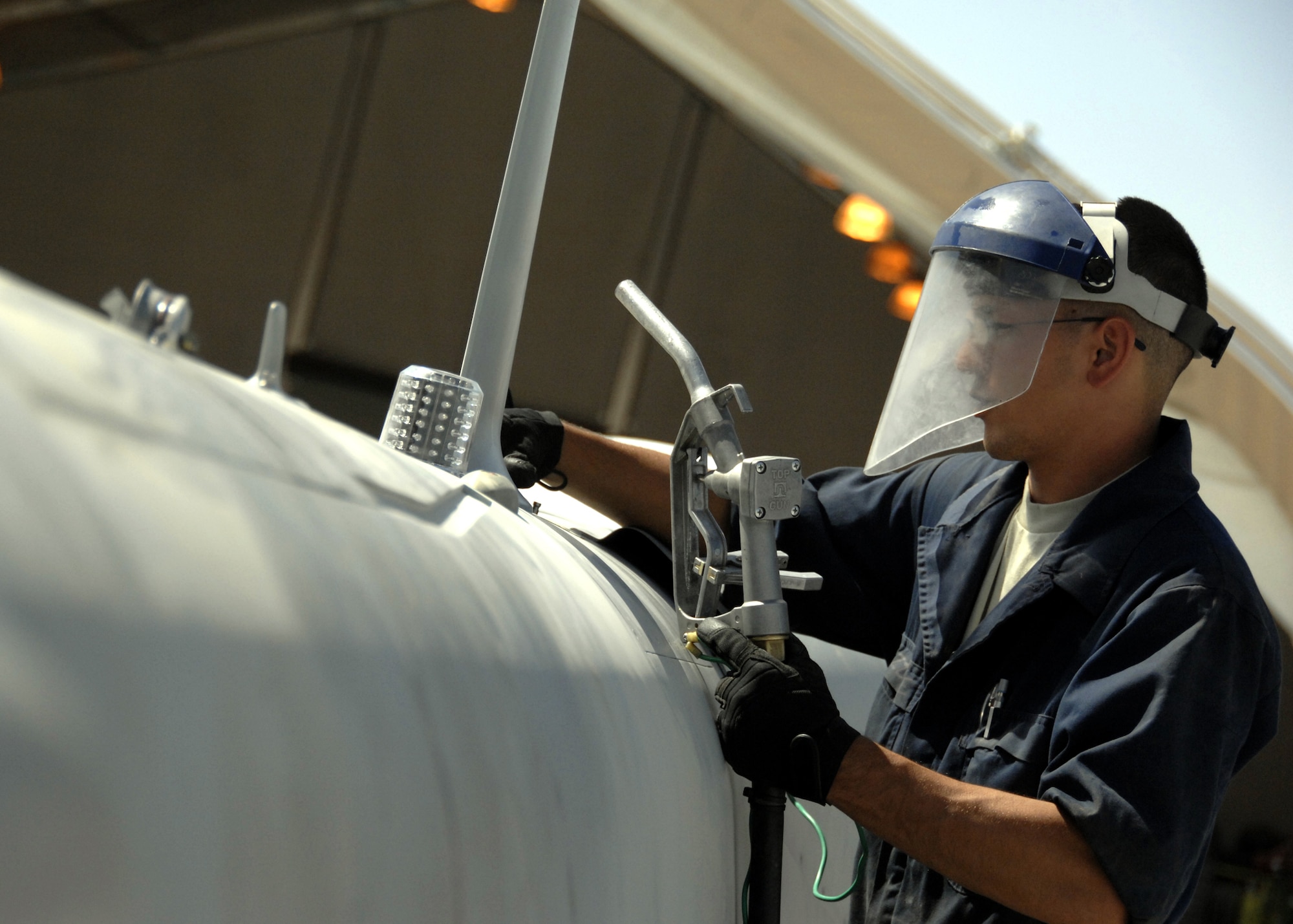 Senior Airman Travis Zablan refuels an MQ-1 Predator here, Oct. 8, 2009. The MQ-1 Predator and MQ-9 Reaper are the only Air Force aircraft on Kandahar that require the crew chiefs or mechanics to refuel themselves. Airman Zablan is a crew chief for the 62nd Expeditionary Reconnaissance Squadron from Creech Air Force Base, Nev., and hails from Kihei, Hawaii. (U.S. Air Force photo/Senior Airman Timothy Taylor)