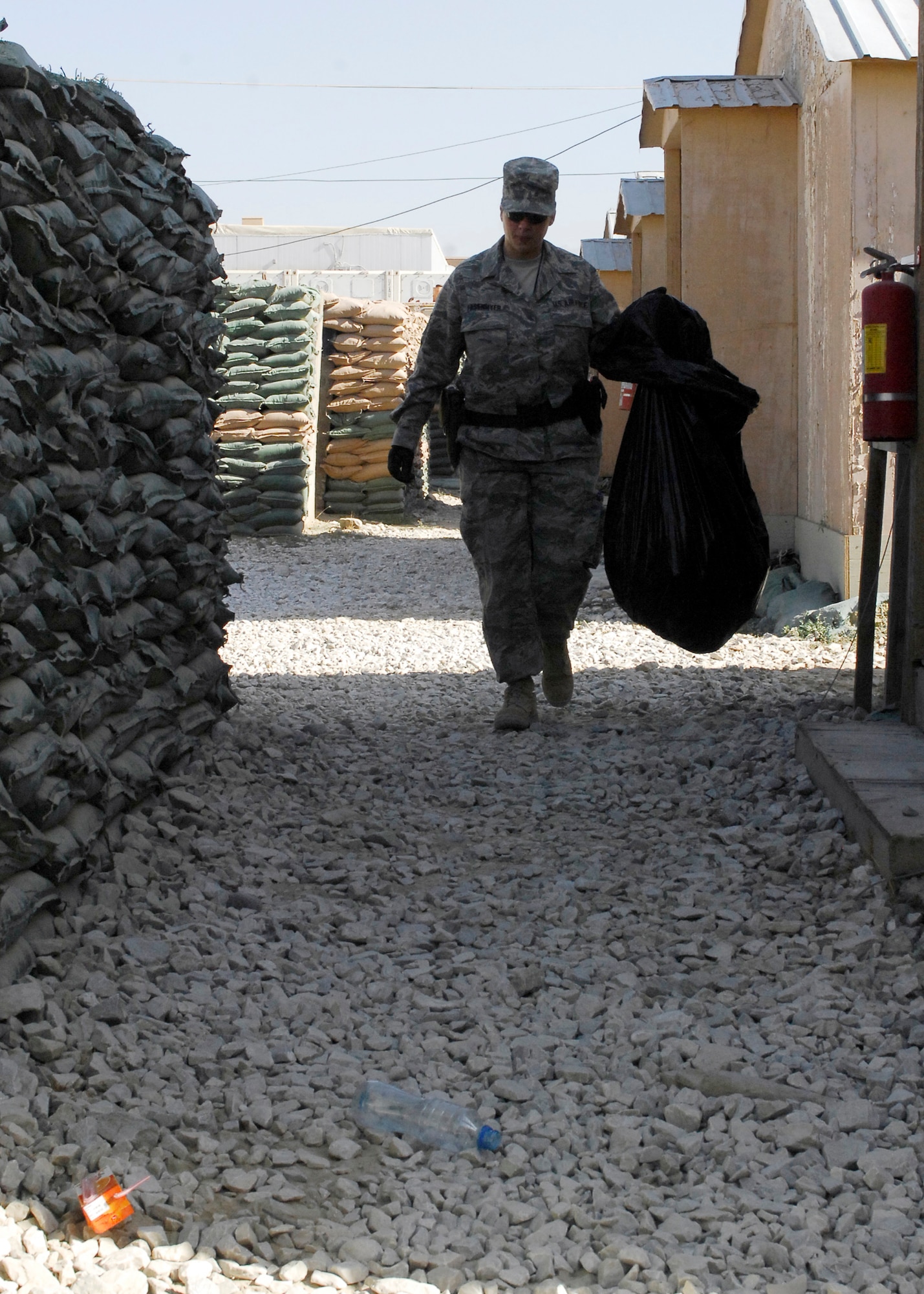 BAGRAM AIRFIELD, Afghanistan -- Staff Sgt. April Fasenmyer, a member of the commander support staff from the 955th Air Expeditionary Squadron, helps the "Green Team" by patrolling for trash in Camp Cunningham here, Oct. 10, 2009.  The Green Team has volunteers help clean the different Air Force camps every Saturday.  Camp Cunningham, where most Bagram Air Force personnel live, is named after Senior Airman Jason D. Cunningham. Airman Cunningham gave his life in Afghanistan while saving 10 lives.  Sergeant Fasenmyer is deployed from Maxwell Air Force Base, Ala., and hails from Shippenville, Pa.  (U.S. Air Force photo/Senior Airman Felicia Juenke)