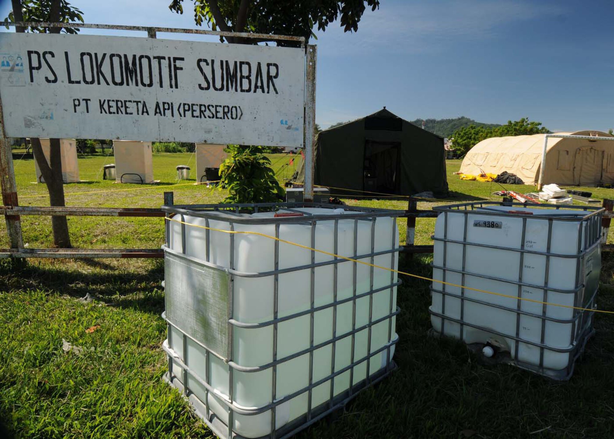 PADANG, Indonesia -- Water tanks positioned in front of a shower kit provide running water to a U.S. Air Force humanitarian assistance rapid response team. The shower kit system was erected by Airmen from the 554th RED HORSE Squadron at Andersen Air Force Base, Guam, deployed here with the  HARRT. The squadron provides the Air Force with a highly mobile civil engineering response force to support contingency and special operations worldwide. (U.S. Air Force photo/Staff Sgt. Veronica Pierce)