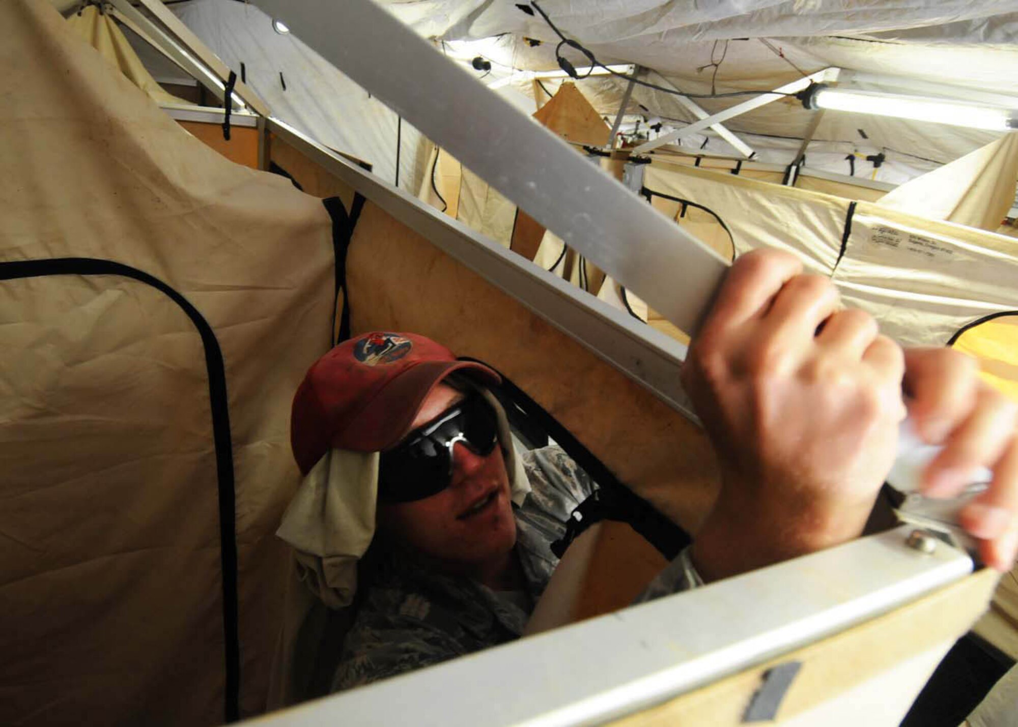 PADANG, Indonesia -- Airman 1st Class Matthew Mahoney installs a portable shower to provide running water to a U.S. humanitarian assistance rapid response team Oct 9.  Airman Mahoney is a structural journeyman from the 554th RED HORSE Squadron at Andersen Air Force Base, Guam, and is deployed here with the HARRT. The squadron provides the Air Force with a highly mobile civil engineering response force to support contingency and special operations worldwide. (U.S. Air Force photo/Staff Sgt. Veronica Pierce)