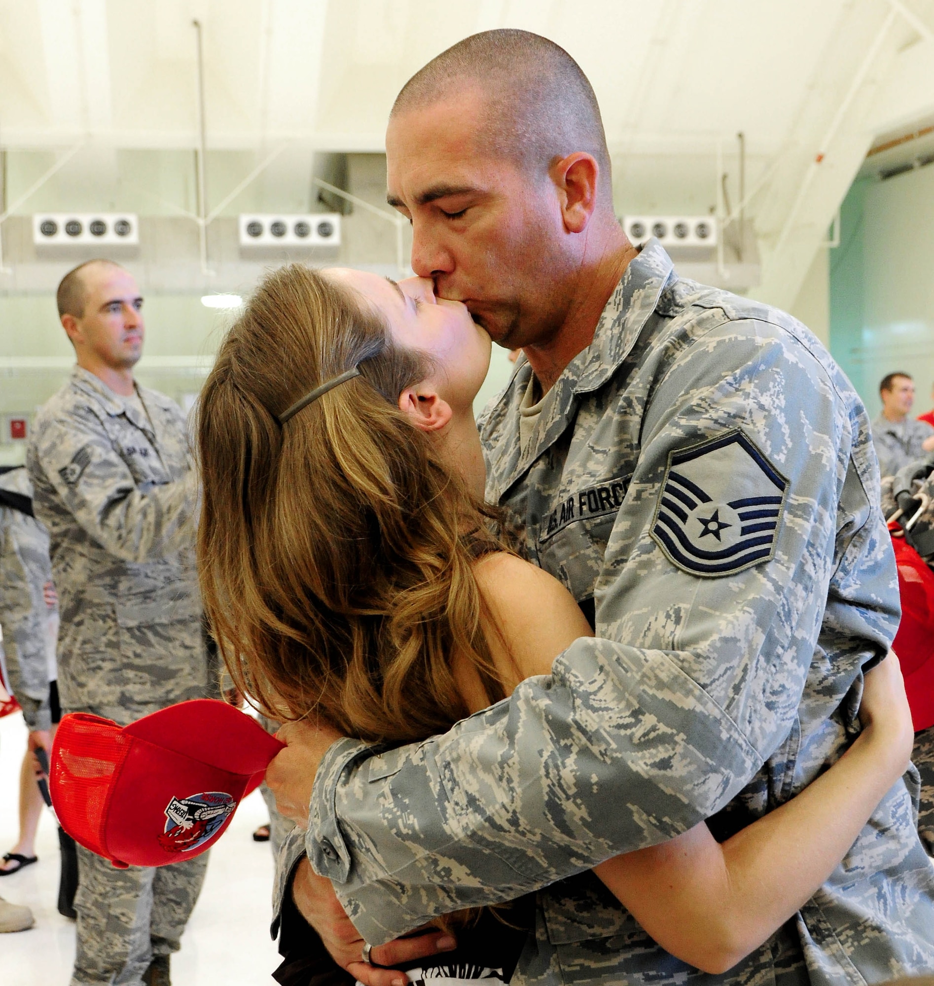 ANDERSEN AIR FORCE BASE - Guam - After a seven month seperation, Master Sgt. Joe Collins races to give his wife, Lisa, a kiss Oct. 10 here. The Airmen were welcomed by members of their squadron, friends and family. This deployment was the unit's first deployment outside of the Pacific Air Forces' theater since Vietnam War. (U.S. Air Force photo by Airman 1st Class Courtney Witt)