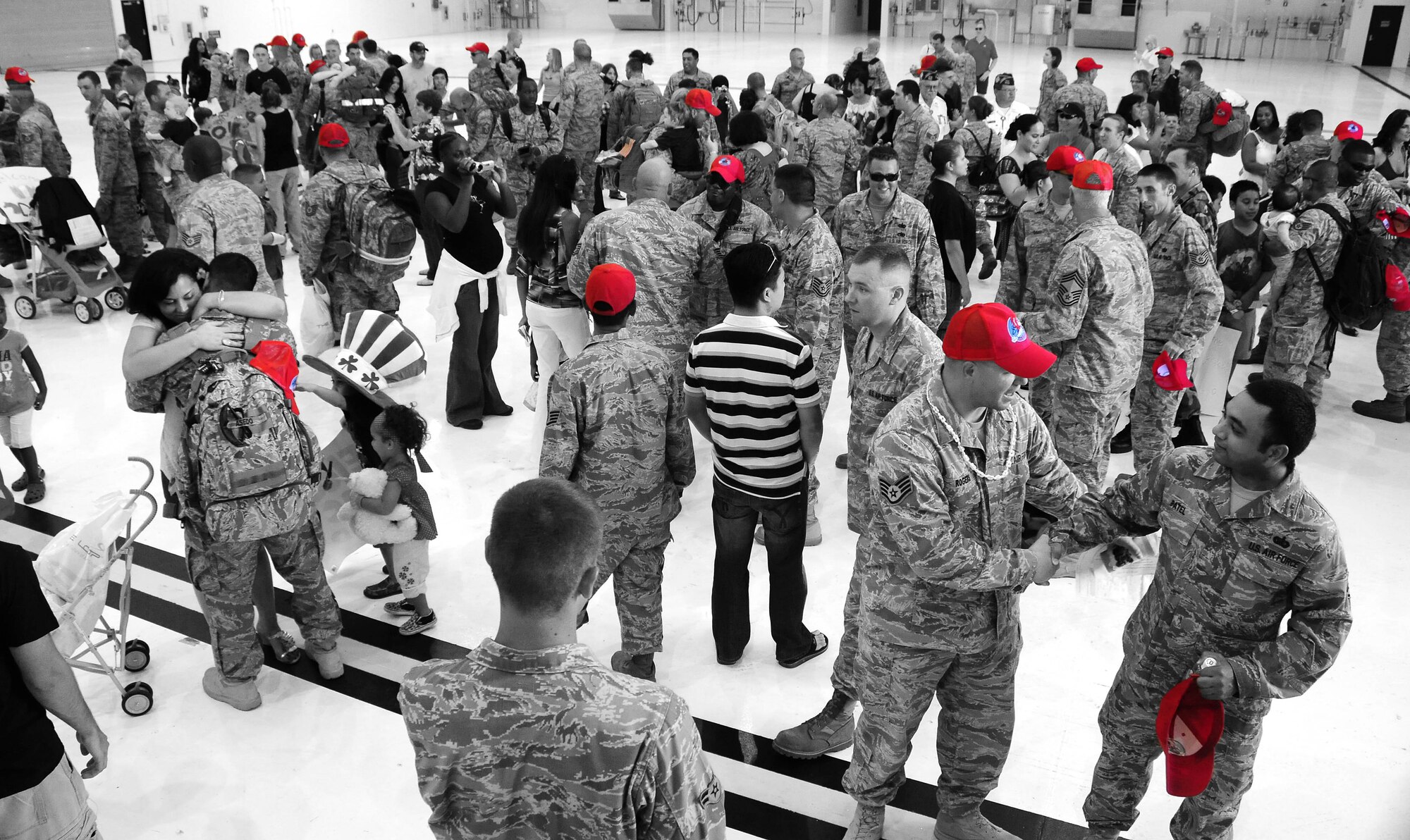 ANDERSEN AIR FORCE BASE - Guam - More than 50 Airmen from the 554th RED HORSE Squadron, greet members of their squadron, friends and family here after returning from a seven-month deployment Oct. 10. This deployment was the unit's first deployment outside of the Pacific Air Forces' theater since Vietnam War. (U.S. Air Force photo illustration by Airman 1st Class Courtney Witt)