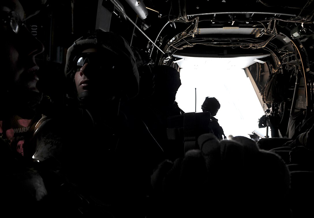 Lance Cpl. Michael R. Gravitt, rifle team leader with E Company, 2nd Battalion, 7th Marine Regiment, looks out the window of an MV-22 Osprey after taking off from the Marine Corps Air Station in Yuma, Ariz., on Oct. 10, 2009. The company's 1st Platoon flew to an urban training range in Twentynine Palms, Calif., in order to capture an insurgent leader, simulating a mission they could be called to perform during their next deployment. The battalion, based in Twentynine Palms, is scheduled to deploy with the 31st Marine Expeditionary Unit in early 2010, with E Company assigned to specialize in helicopter insertions and raids. Gravitt, 20, is a native of Moline, Ill.