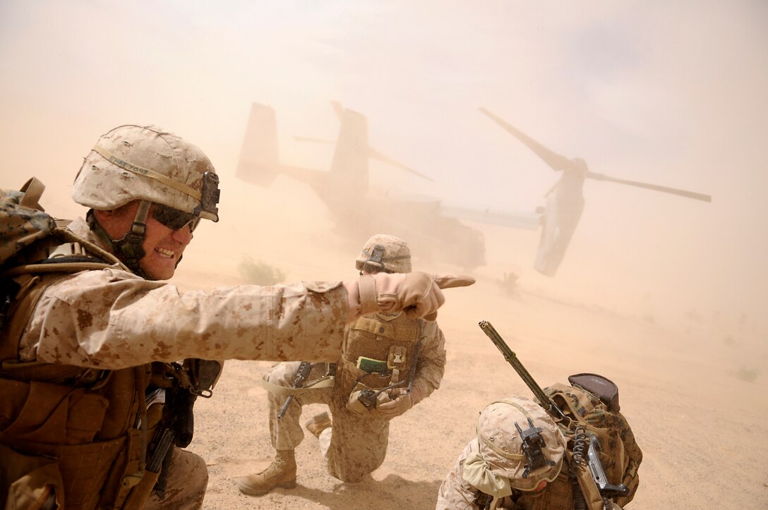Cpl. Corey C. Haeuplte, squad leader with E Company, 2nd Battalion, 7th Marine Regiment, shouts commands to his squad moments after landing on the outskirts of an urban training range in Twentynine Palms, Calif., on Oct. 10, 2009. Loading on to MV-22 Osprey aircraft at the Marine Corps Air Station in Yuma, Ariz, the company's 1st Platoon flew to Twentynine Palms, Calif., in order to capture an insurgent leader, simulating a mission they could be called to perform during their next deployment. The battalion, based in Twentynine Palms, is scheduled to deploy with the 31st Marine Expeditionary Unit in early 2010, with E Company assigned to specialize in helicopter insertions and raids. Haeuplte, 23, is a native of Smyrna, Tenn.