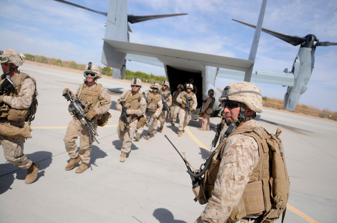Staff Sgt. Harold Young, platoon sergeant with E Company, 2nd Battalion, 7th Marine Regiment, watches his Marines exit an MV-22 Osprey on the flight line of the Marine Corps Air Station in Yuma, Ariz., on Oct. 10, 2009, following a helicopter raid exercise. For most of the Marines including Young, the ride on the Corps' tilt-rotor aircraft was a first. The battalion, based in Twentynine Palms, Calif., is scheduled to deploy with the 31st Marine Expeditionary Unit in early 2010, with E Company assigned to specialize in helicopter insertions and raids.