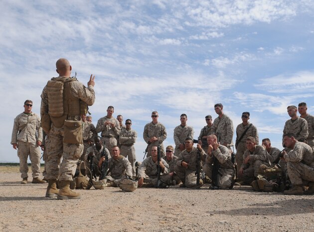 Following a helicopter raid exercise, platoon commander, 2nd Lt. Mitchell Steen, reviews the lessons learned with 1st Platoon, E Company, 2nd Battalion, 7th Marine Regiment, near the flight line at the Marine Corps Air Station in Yuma, Ariz., on Oct. 10, 2009. The battalion, based in Twentynine Palms, Calif., is scheduled to deploy with the 31st Marine Expeditionary Unit in early 2010, with E Company assigned to specialize in helicopter insertions and raids.