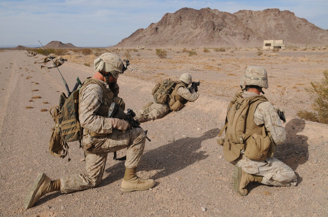 Marines with 2nd Battalion, 7th Marine Regiment, seek cover as they assault toward a structure in the Barry M. Goldwater Range east of the Marine Corps Air Station in Yuma, Ariz., Oct. 10, 2009. The assault exercise was held in preparation for the battalion's deployment with the 31st Marine Expeditionary Unit based out of Okinawa, Japan in early 2010.