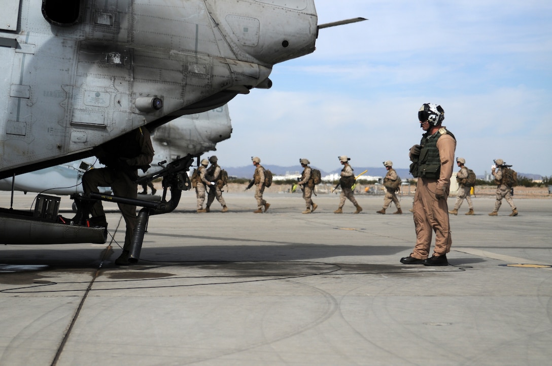 Marines with 2nd Battalion, 7th Marine Regiment, board CH-46E Sea Knights at the Marine Corps Air Station in Yuma, Ariz., Oct. 10, 2009. The aircraft's crew flew the Marines approximately 70 miles eastward into the Barry M. Goldwater Range and fired on simulated enemy automobiles before reaching a landing zone where the battalion Marines disembarked and rapidly established a security perimeter while the aircraft flew off. The battalion is based at Twentynine Palms, Calif., and scheduled to deploy with the 31st Marine Expeditionary Unit based in Okinawa, Japan in early 2010.