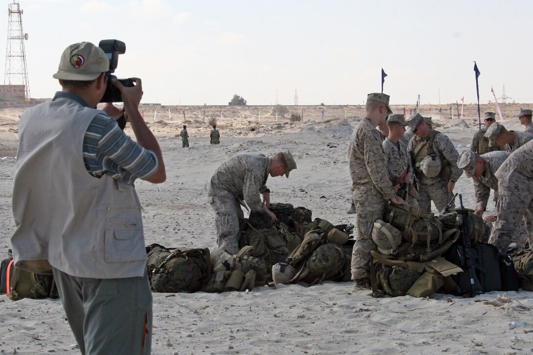 An Egyptian cameraman photographs Marines from India Company, Battalion Landing Team, 3rd Battalion, 2nd Marine Regiment, 22nd Marine Expeditionary Unit, during an offload from amphibious dock landing ship USS Fort McHenry (LSD 43) for Exercise Bright Star 2009 in Egypt Oct. 10, 2009. The multinational exercise is designed to improve readiness, interoperability, and strengthen the military and professional relationships among U.S., Egyptian and participating forces. Bright Star is conducted by U.S. Central Command and held every two years. Elements of the 22nd MEU are currently are participating in the multi-national exercise while serving as the theater reserve force for U.S. Central Command.::r::::n::(Official Marine Corps Photo by Cpl. Theodore W. Ritchie)::r::::n::