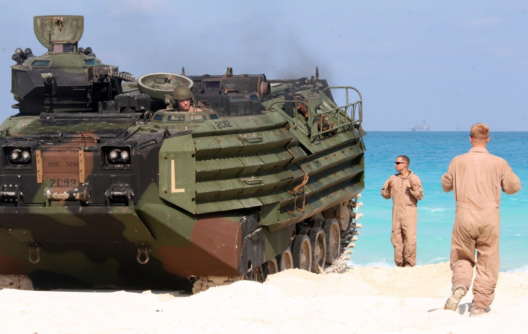 Two Marines from Amphibious Assault Vehicle Platoon, India Company, Battalion Landing Team, 3rd Battalion, 2nd Marine Regiment, 22nd Marine Expeditionary Unit, ground-guide an AAV during an offload from amphibious dock landing ship USS Fort McHenry (LSD 43) for Exercise Bright Star 2009 in Egypt Oct. 10, 2009. The multinational exercise is designed to improve readiness, interoperability, and strengthen the military and professional relationships among U.S., Egyptian and participating forces. Bright Star is conducted by U.S. Central Command and held every two years. Elements of the 22nd MEU are currently are participating in the multi-national exercise while serving as the theater reserve force for U.S. Central Command.::r::::n::(Official Marine Corps photo by Cpl. Theodore W. Ritchie)