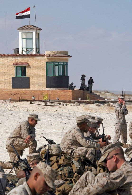 Marines from India Company, Battalion Landing Team, 3rd Battalion, 2nd Marine Regiment, 22nd Marine Expeditionary Unit, await transportation during an offload from amphibious dock landing ship USS Fort McHenry (LSD 43) for Exercise Bright Star 2009 in Egypt Oct. 10, 2009. The multinational exercise is designed to improve readiness, interoperability, and strengthen the military and professional relationships among U.S., Egyptian and participating forces. Bright Star is conducted by U.S. Central Command and held every two years. Elements of the 22nd MEU are currently are participating in the multi-national exercise while serving as the theater reserve force for U.S. Central Command.::r::::n::(Official Marine Corps photo by Cpl. Theodore W. Ritchie)::r::::n::