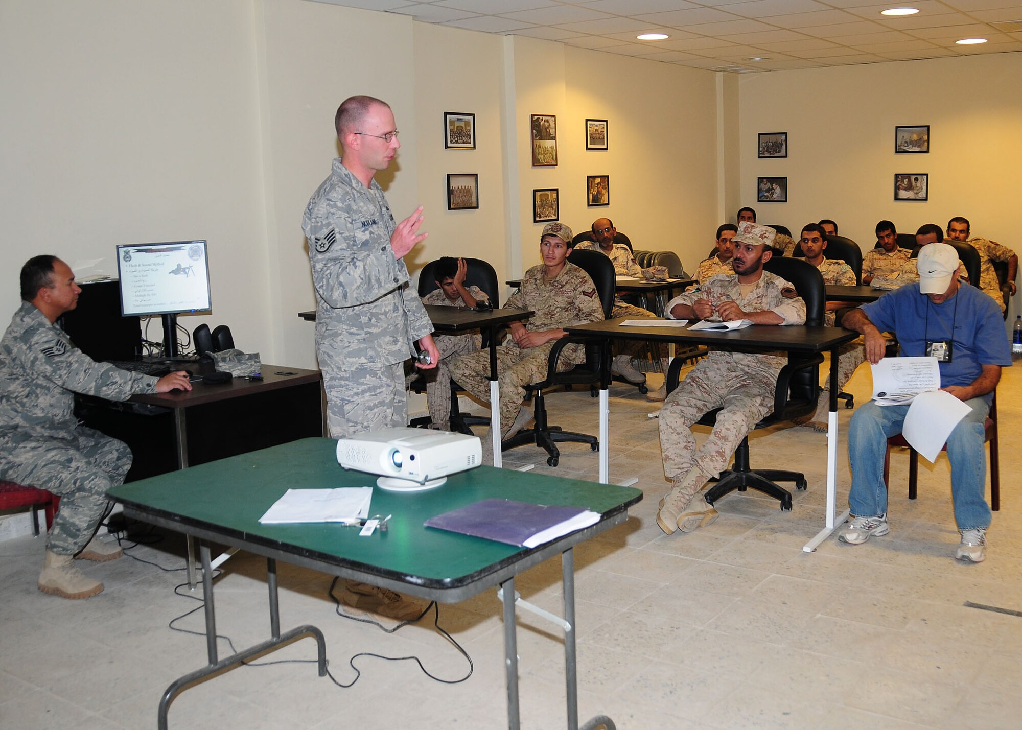 SOUTHWEST ASIA -- Staff Sgt. Devon Nodland, 386th Expeditionary Security Forces Squadron host nation trainer, instructs host nation security forces members on filling out range cards during level-1 training at an undisclosed location in Southwest Asia Oct. 11, 2009.  Level-1 training is designed to strengthen the ground combat capability of host nation military forces.  Sergeant Nodland is deployed from the 3rd Wing, Elmendorf Air Force Base, Alaska, and hails from Hazen, N.D.  (U.S. Air Force photo/Tech. Sgt. Tony Tolley)
