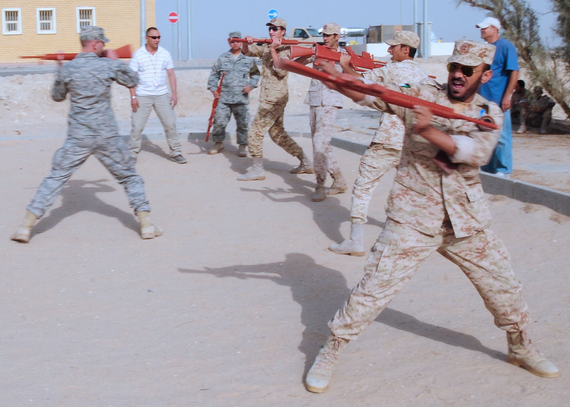 SOUTHWEST ASIA -- Staff Sgt. Devon Nodland, 386th Expeditionary Security Forces Squadron host nation trainer, shows host nation security forces members rifle fighting techniques during level 1training at an undisclosed location in Southwest Asia Oct. 11, 2009.  Level-1 training is designed to strengthen the ground combat capability of host nation military forces.  Sergeant Nodland is deployed from the 3rd Wing, Elmendorf Air Force Base, Alaska, and hails from Hazen, N.D.  (U.S. Air Force photo/Tech. Sgt. Tony Tolley)