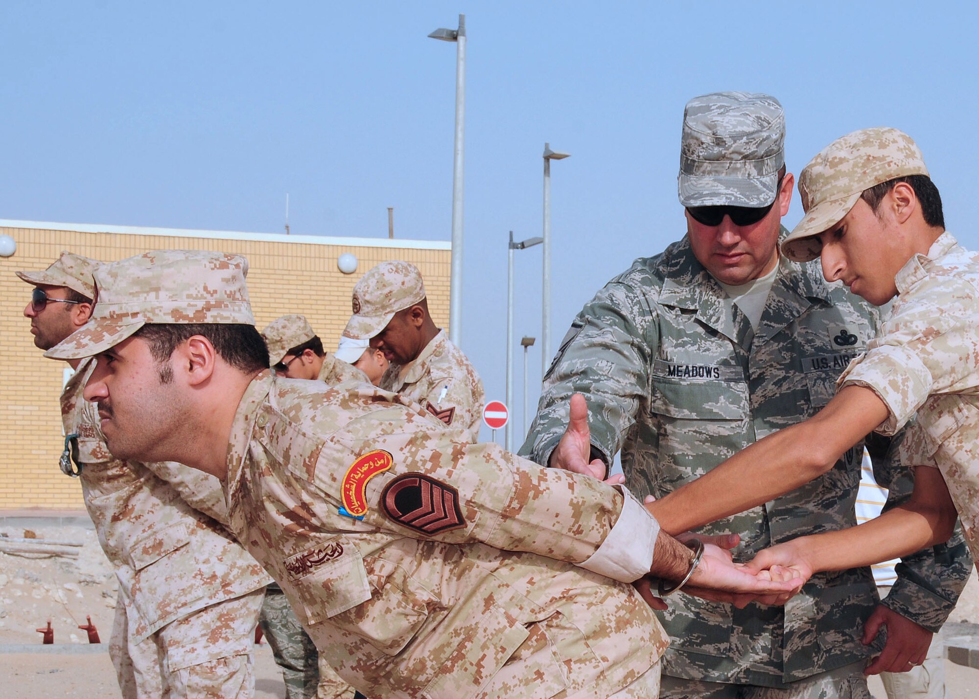 SOUTHWEST ASIA -- Master Sgt. Terry Meadows, 386th Expeditionary Security Forces Squadron host nation training non-commissioned officer in charge, shows a host nation security forces member how to take control of a member in handcuffs during Level-1 training at an undisclosed location in Southwest Asia Oct. 11, 2009.  Level-1 training is designed to strengthen the ground combat capability of host nation military forces.  Sergeant Meadows is deployed from the 14th Flying Training Wing, Columbus Air Force Base, Miss., and hails from Albuquerque, N.M.  (U.S. Air Force photo/Tech. Sgt. Tony Tolley)