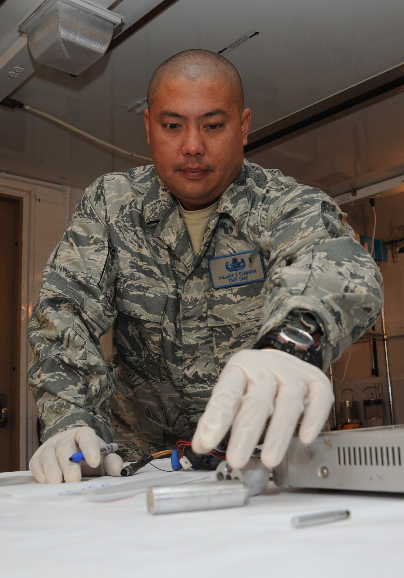 CAMP VICTORY, Iraq -- Air Force Tech. Sgt. William Cameron, Combined Joint Task Force Troy Combined Explosive Exploitation Cell Triage Lab noncommissioned officer in charge, catalogs evidence collected from an improvised explosive device here Oct. 10, 2009. Sergeant Cameron is an explosive ordnance disposal technician who ensures evidence components are safe to handle by removing hazardous materials. This allows Functional Analysis Cell members to safely analyze evidence and piece together a true picture of the IED threat in Iraq. Sergeant Cameron is deployed from Detachment 63, Indian Head Naval Ordnance Station, Md., and hails from Middleburg, Fla. (U.S. Air Force photo/Tech. Sgt. Johnny L. Saldivar)