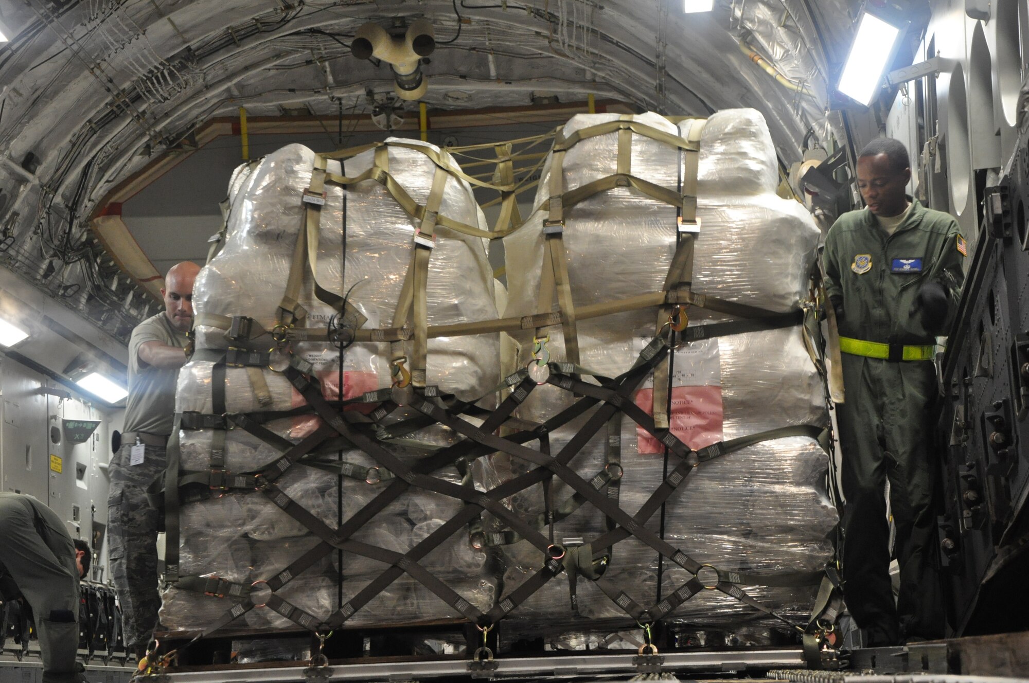 Airmen from McChord Air Force Base, Wash., and Hickam AFB, Hawaii, and Air Mobility Command civilians offload Federal Emergency Management Agency cargo from a McChord C-17 Globemaster III Oct. 10 at Pago Pago International Airport, American Samoa. (U.S. Air Force photo/Staff Sgt. Eric Burks)