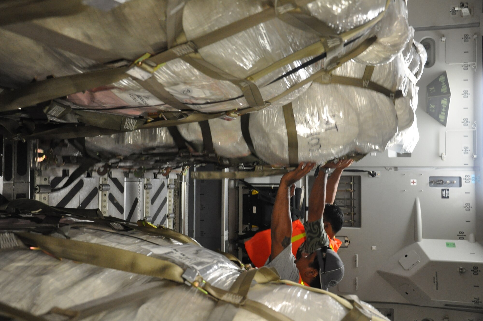 Airmen from McChord Air Force Base, Wash., and Hickam AFB, Hawaii, and Air Mobility Command civilians offload Federal Emergency Management Agency cargo from a McChord C-17 Globemaster III Oct. 10 at Pago Pago International Airport, American Samoa. (U.S. Air Force photo/Staff Sgt. Eric Burks)