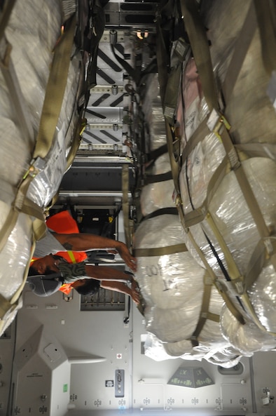 Airmen from McChord Air Force Base, Wash., and Hickam AFB, Hawaii, and Air Mobility Command civilians offload Federal Emergency Management Agency cargo from a McChord C-17 Globemaster III Oct. 10 at Pago Pago International Airport, American Samoa. (U.S. Air Force photo/Staff Sgt. Eric Burks)