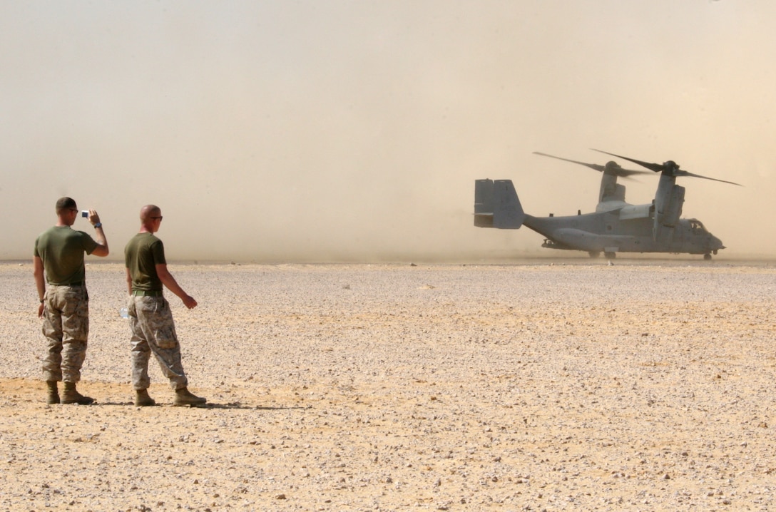 A Marine from India Company, Battalion Landing Team, 3rd Battalion, 2nd Marine Regiment, 22nd Marine Expeditionary Unit, photographs an MV-22B Osprey from Marine Medium Tiltrotor Squadron 263 (Reinforced), 22nd MEU, at a bivouac site during Exercise Bright Star 2009 in Egypt Oct. 11, 2009. The multinational exercise is designed to improve readiness, interoperability, and strengthen the military and professional relationships among U.S., Egyptian and participating forces. Bright Star is conducted by U.S. Central Command and held every two years. Elements of the 22nd MEU are currently are participating in the multi-national exercise while serving as the theater reserve force for U.S. Central Command.::r::::n::(Official Marine Corps photo by Cpl. Theodore W. Ritchie)::r::::n::