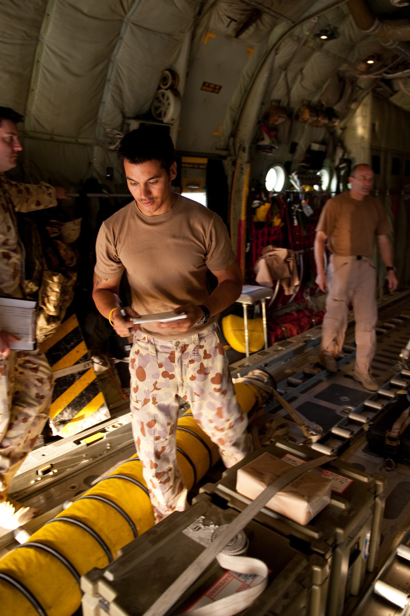 Royal Australian Air Force Corporal Mick Godfrey, No. 37 Squadron air loading team member, checks air loading documents for cargo aboard a C-130J, Oct. 11, in Southwest Asia. The No. 37 Squadron C-130Js provide intra-theater combat airlift support throughout Southwest Asia in support of Australian and allied forces. Corporal Godfrey is deployed from RAAF Base Richmond, Australia, in support of Operation Slipper, Australian's military contribution to international campaigns against terrorism. (U.S. Air Force photo/Staff Sgt. Robert Barney) 