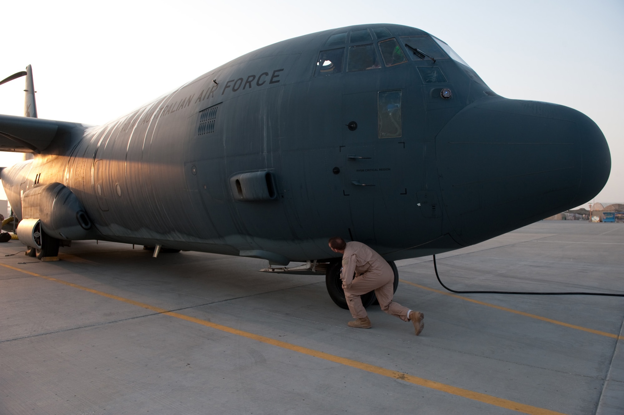 Royal Australian Air Force Flight Lieutenant Stuart Wright, No. 37 Squadron pilot, performs a C-130J pre-flight check prior to a mission, Oct. 11, in Southwest Asia. The No. 37 Squadron C-130Js provide intra-theater combat airlift support throughout Southwest Asia in support of Australian and Allied forces. Flight Lieutenant Wright is deployed from RAAF Base Richmond, Australia, in support of Operation Slipper, Australian's military contribution to international campaigns against terrorism. (U.S. Air Force photo/Staff Sgt. Robert Barney) 