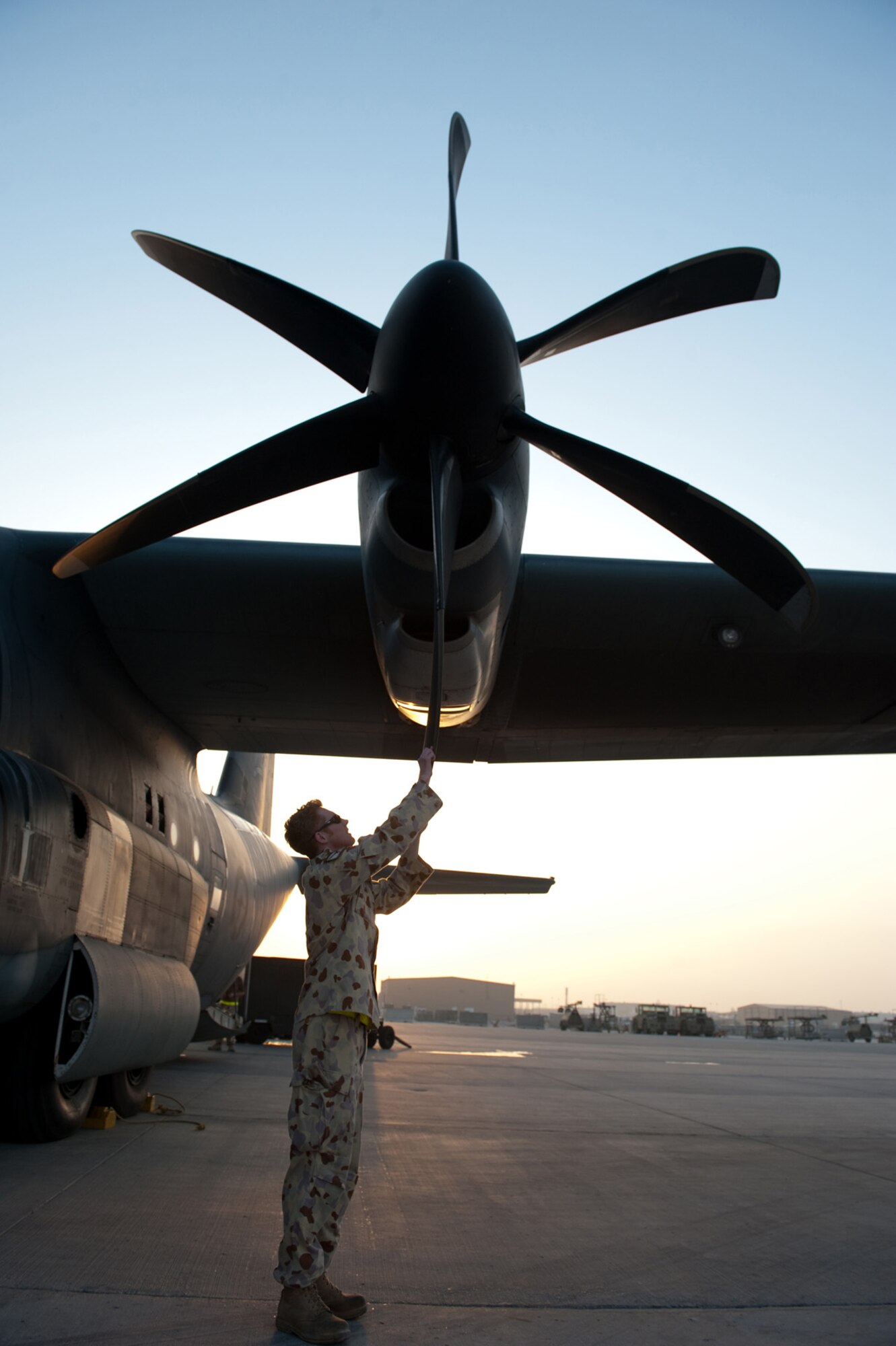 Royal Australian Air Force Corp. Stuart Needham, No. 37 Squadron aircraft technician, inspects a C-130J for prop damage to ensure serviceability, Oct. 11, in Southwest Asia. No. 37 Squadron C-130Js provide intra-theater combat airlift support throughout Southwest Asia in support of Australian and allied forces. Corporal Needham is deployed from RAAF Base Richmond, Australia, in support of Operation Slipper, Australian's military contribution to international campaigns against terrorism. (U.S. Air Force photo/Staff Sgt. Robert Barney)