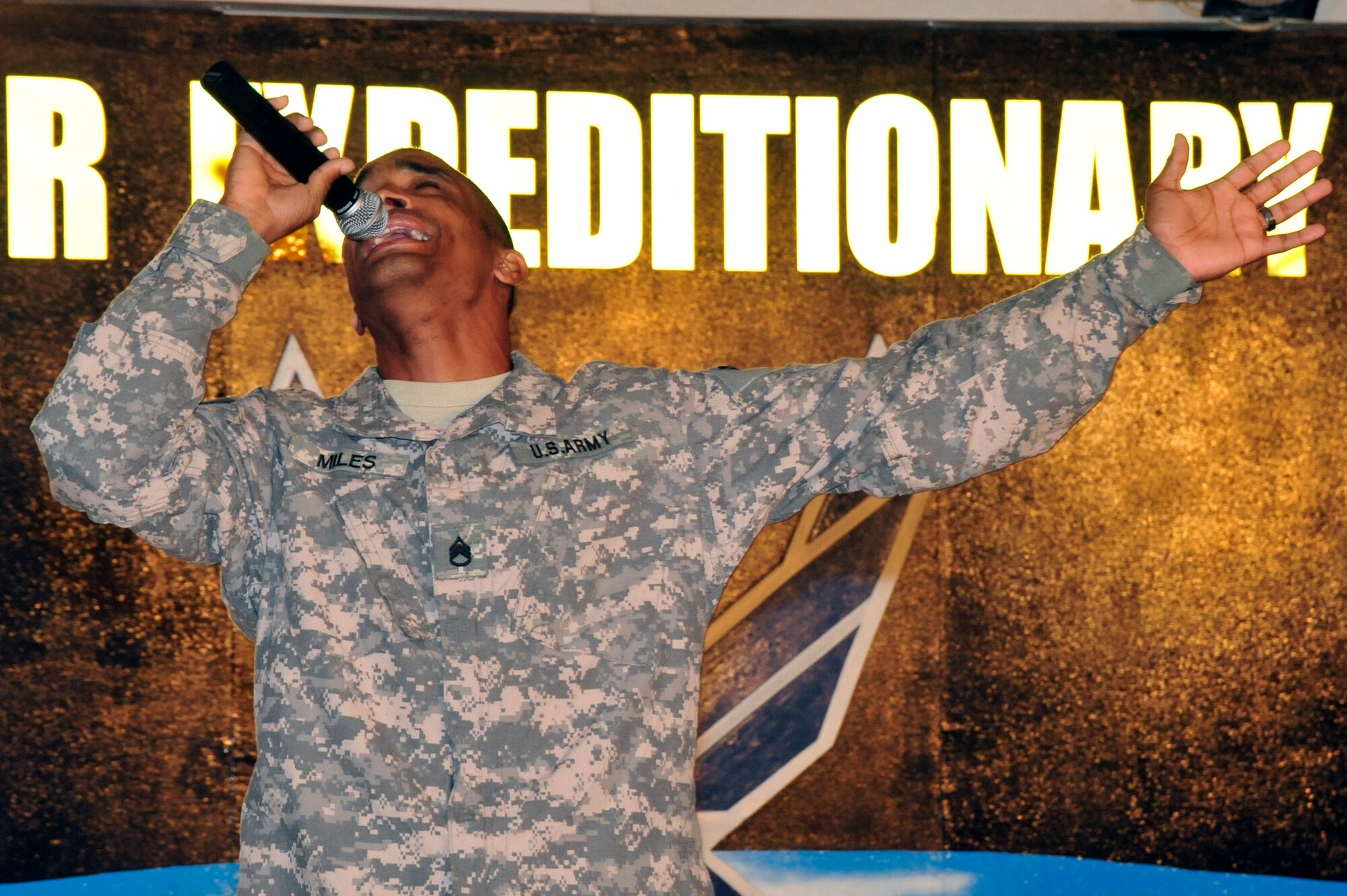 SOUTHWEST ASIA -Staff Sgt. Sean Miles, U.S. Army, sings a gospel song during the Gospel Explosion here Oct. 11, 2009. The Gospel Explosion demonstrated the talents of service members through singing, dancing, music and a skit. (U.S. Air Force photo/Tech. Sgt. Charles Larkin Sr)