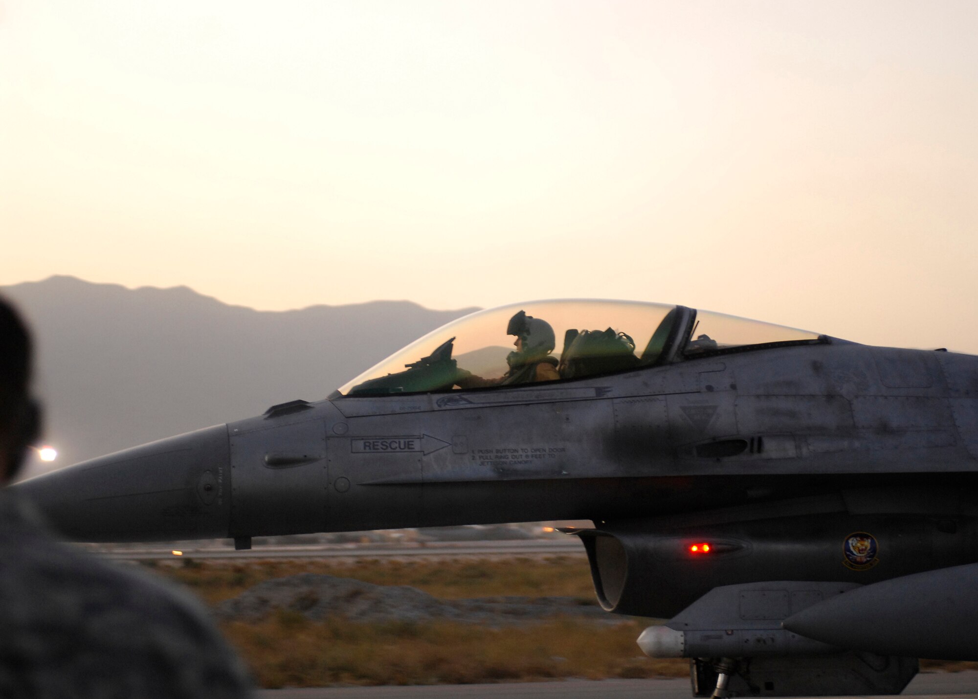 BAGRAM AIRFIELD, Afghanistan -- Airmen watch as F-16 Fighting Falcons, from the 79th Expeditionary Fighter Squadron, advance to their designated parking spot after receiving an inspection here, Oct. 11, 2009.  The aircraft receive inspections before takeoff and after landing to ensure the safety of the aircraft and pilot.  Known as the "Tigers," the F-16s are deployed from the 79th Fighter Squadron out of Shaw Air Force Base, S.C.  The Tigers mission while here is to provide tactical air-to-air and air-to-ground support while supporting Operation Enduring Freedom.  (U.S. Air Force photo/Senior Airman Felicia Juenke)