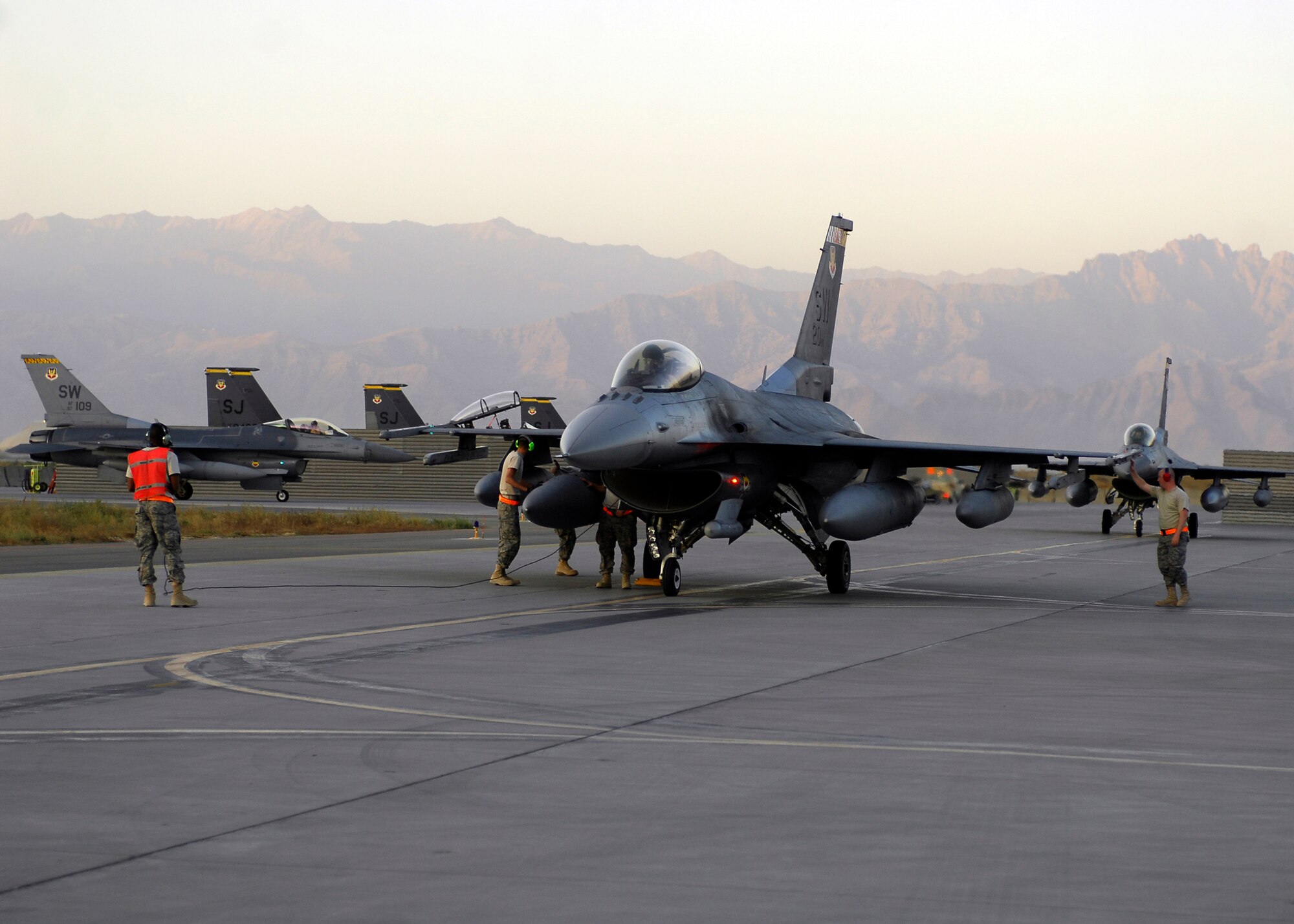 BAGRAM AIRFIELD, Afghanistan -- Staff Sgt. Joseph Myers, a dedicated crew chief from the 79th Expeditionary Fighter Squadron, halts an F-16 Fighting Falcon so the Airmen can perform an inspection before advancing to the designated parking spot here, Oct. 11, 2009.  The aircraft receive inspections before takeoff and after landing to ensure the safety of the aircraft and pilot.  Sergeant Myers is deployed from Shaw Air Force Base, S.C., and hails from Shreveport, La.  (U.S. Air Force photo/Senior Airman Felicia Juenke)