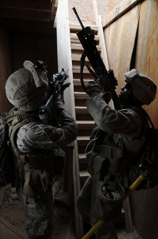 Cpl. Keith A. Nuckles, left, and Lance Cpl. Carlos Batista, with E Company, 2nd Battalion, 7th Marine Regiment, prepare to climb to the roof of a building to take out a mortar position in an urban training range at the U.S. Army Yuma Proving Ground in Arizona during a helicopter raid exercise Oct. 12, 2009. Sixteen Marines landed on the outskirts of the range in four UH-1 helicopters and stormed the buildings from all sides searching for two insurgent leaders, simulating a mission they could be called to perform during their next deployment. The battalion, based in Twentynine Palms, Calif., is scheduled to deploy with the 31st Marine Expeditionary Unit in early 2010, with E Company assigned to specialize in helicopter insertions and raids. Nuckles, 21, is a native of Pacoima, Calif., and Batista, 20, is a Miami-native.