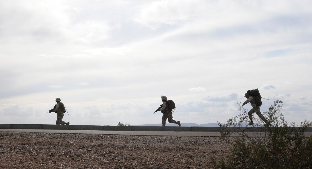 Members of E Company, 2nd Battalion, 7th Marine Regiment, run toward a landing site where they will be extracted in UH-1 helicopters from an urban training range at the U.S. Army Yuma Proving Ground in Arizona during a helicopter raid exercise Oct. 12, 2009. Sixteen Marines landed on the outskirts of the range in four UH-1 helicopters and stormed the buildings from all sides searching for two insurgent leaders, simulating a mission they could be called to perform during their next deployment. The battalion, based in Twentynine Palms, Calif., is scheduled to deploy with the 31st Marine Expeditionary Unit in early 2010, with E Company assigned to specialize in helicopter insertions and raids.