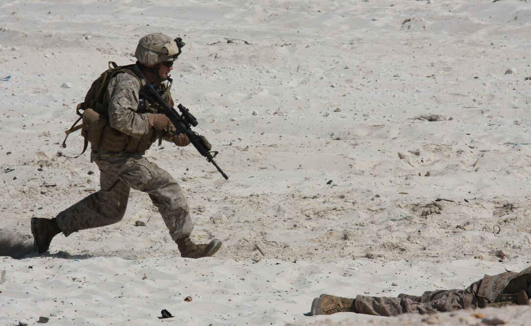 A Marine from the 22nd Marine Expeditionary Unit, rushes across the beach to take up position during an amphibious assault demonstration conducted as part of Bright Star 2009 in Egypt Oct. 12, 2009. The multinational exercise is designed to improve readiness, interoperability, strengthen the military and professional relationships among U.S., Egyptian and participating forces. Bright Star is conducted by U.S. Central Command and held every two years. Elements of the 22nd MEU are currently are participating in the multi-national exercise while serving as the theater reserve force for U.S. Central Command. ::r::::n::(Official Marine Corps photo by Staff Sgt. Matt Epright)::r::::n::