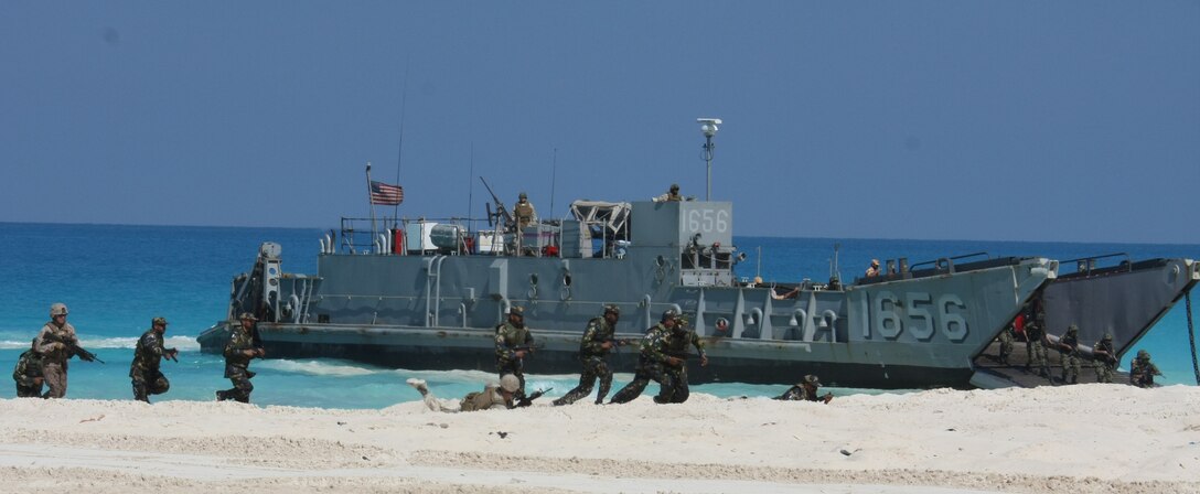 U.S. Marines from the 22nd Marine Expeditionary Unit (MEU), along with Marines from Pakistan and Kuwait, storm ashore during an amphibious assault demonstration conducted as part of Bright Star 2009 in Egypt Oct. 12, 2009. The multinational exercise is designed to improve readiness, interoperability, strengthen the military and professional relationships among U.S., Egyptian and participating forces. Bright Star is conducted by U.S. Central Command and held every two years. Elements of the 22nd MEU are currently are participating in the multi-national exercise while serving as the theater reserve force for U.S. Central Command. ::r::::n::(Official Marine Corps photo by Staff Sgt. Matt Epright)::r::::n::